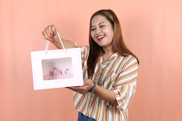 Fototapeta na wymiar Asian happy female woman girl holds shopping package