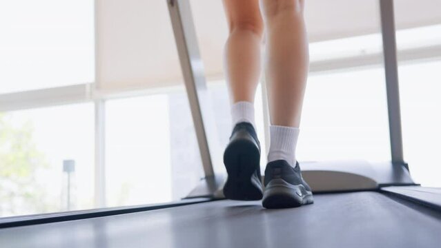 Fitness female walking on treadmill. Asian woman workout cardio and training at gym