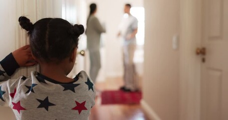 Back, parents arguing and girl in the hallway of her house, watching a fight, conflict or dispute. Kids, divorce or breakup with a young female child looking at her mother and father in an argument - Powered by Adobe