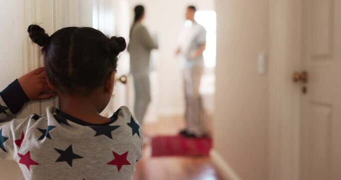 Back, parents arguing and girl in the hallway of her house, watching a fight, conflict or dispute. Kids, divorce or breakup with a young female child looking at her mother and father in an argument