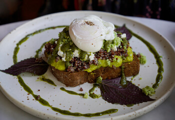 Well presented avocado and poached egg toast for breakfast