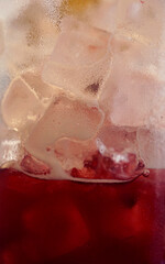 Background and texture of cold iced pink juice glass sweating
