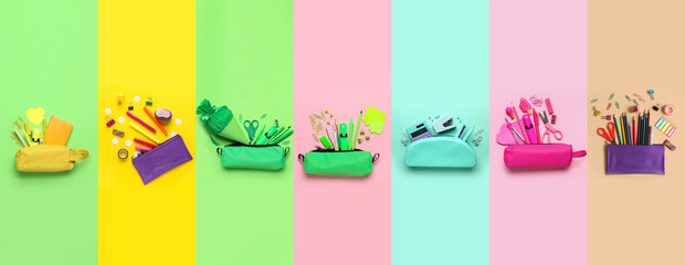 Collection of pencil cases with school stationery on color background