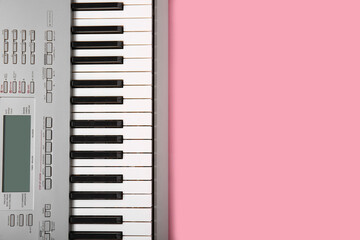 Modern synthesizer keyboard on pink background