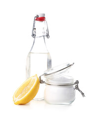 Jar with baking soda and bottle of vinegar for cleaning on white background