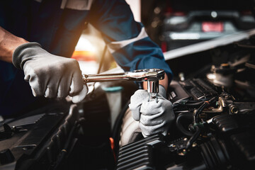 Car care maintenance and servicing, Hand technician auto mechanic using the wrench to fix car or...