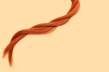 Braided ginger hair on color background