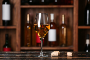 Glass of exquisite wine on table in cellar