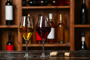 Glasses of exquisite wine on table in cellar