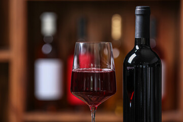 Bottle and glass of red wine in cellar