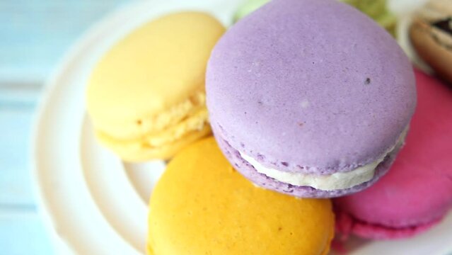 Close up of macaroon on blue background with copy space 