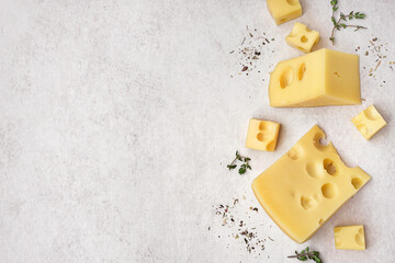 Pieces of Swiss cheese on white background