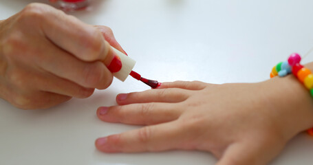Mom paints her daughter's nails