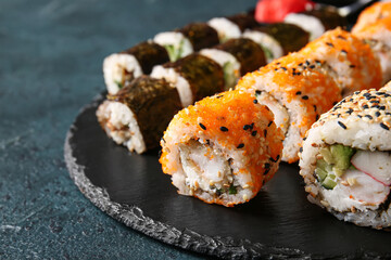 Tasty sushi rolls on dark background, closeup view