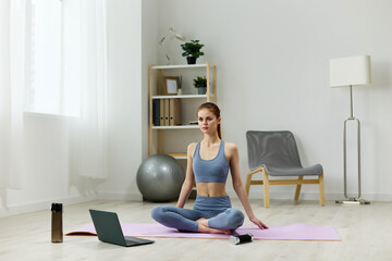 Fototapeta na wymiar woman dumbbells lotus laptop mat training yoga health video home lifestyle