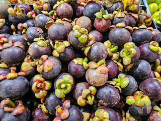 Top view Pile of Mangosteens in a supermarket local market in Thailand, Bunch of organic mangosteen ready to eat. Fresh mangosteen background