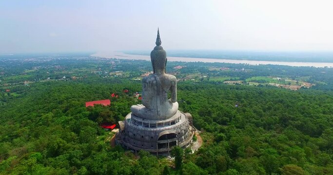 aerial view Big white buddha statue on mountain for thai people travel visit and respect .praying at Wat Roi Phra Phutthabat Phu Manorom on May 15, 2017 in Mukdahan, Thailand..Big Buddha Wat Phu 