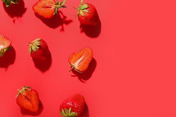 Many fresh strawberries on red background