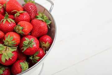 Colander with fresh strawberries, closeup
