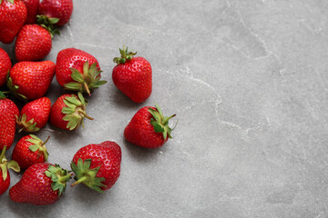 Fresh strawberries on grey background