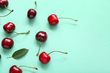 Many sweet cherries on turquoise background