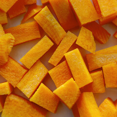 carrot cut into cubes close-up. A set of vitamins. Vegan food. Healthy food. Square image.