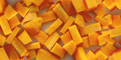 carrot cut into cubes close-up. A set of vitamins. Vegan food. Healthy food. Horizontal image....