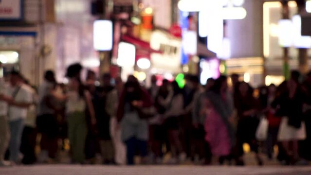 SHIBUYA, TOKYO, JAPAN : Slow motion shot of crowd of people walking at Shibuya crossing at night. Busy downtown area in Tokyo. Japanese people, urban city nightlife and metropolis concept video.