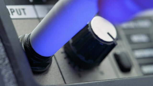 Man plug in jack and tuning volume knob on guitar amplifier. 4k video footage UHD 3840x2160