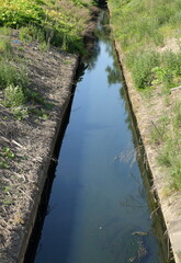 Narrow shallow concreted straight sewer channel