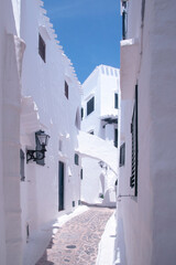 Streets and white walls of touristic fishing village of Binibeca Vell in Menorca, Spain.