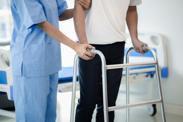 The patient is doing physiotherapy with a specialist physiotherapist, the patient is practicing walking using a walking brace with the help of a physiotherapist. Physiotherapy concepts from experts.