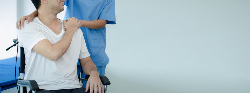 Male patient sitting in wheelchair undergoing a medical examination with specialist physician, treating injuries Getting medical treatment from specialist doctor can get the right and proper treatment