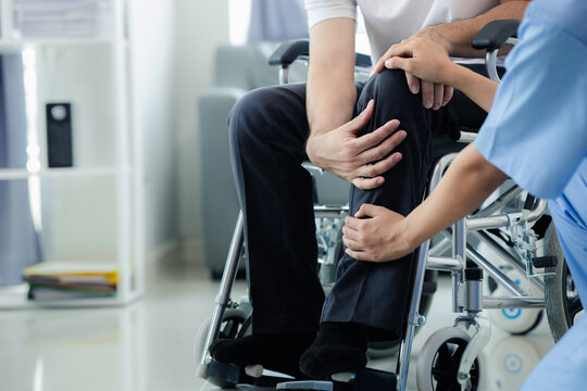 Male patient sitting in wheelchair undergoing a medical examination with specialist physician, treating injuries Getting medical treatment from specialist doctor can get the right and proper treatment