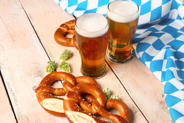 Flag of Bavaria, mugs with beer and pretzels on white wooden background - obrazy, fototapety, plakaty