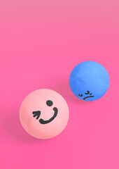 笑顔のピンクと青い泣き顔のウッドボール