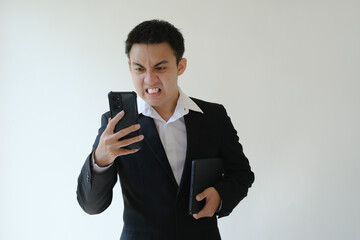 A young Asian boss is angry on the phone. Isolated white background.