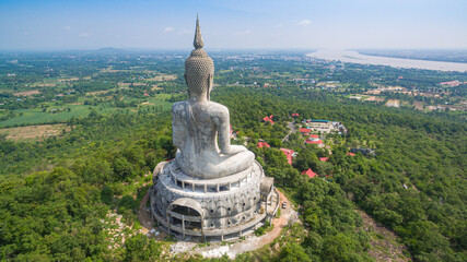 .aerial view Big white buddha statue on mountain for thai people travel visit and respect .praying...