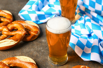 Flag of Bavaria, mug with beer and pretzels on dark background