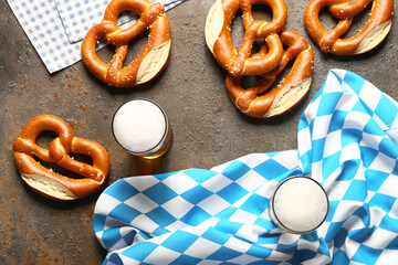 Flag of Bavaria, mugs with beer and pretzels on dark background