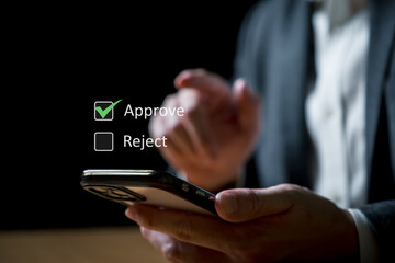 Business man consider to approve online approval request from smartphone device. Online approval...