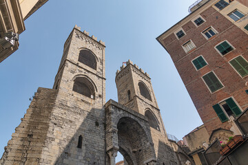 A view of the old medieval stone entrance arch towers of Porta Soprana in Genoa, Italy