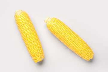 Fresh corn cobs on grey background