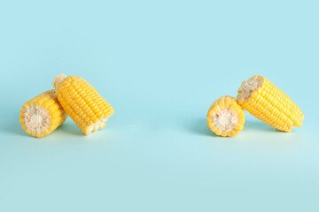 Cut fresh corn cobs on blue background