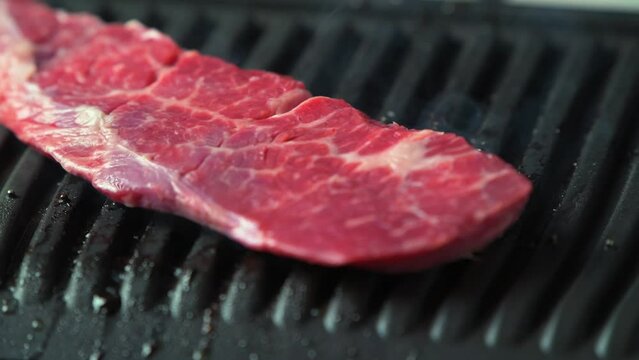Hot delicious beefsteak on electic grill. 4k video footage