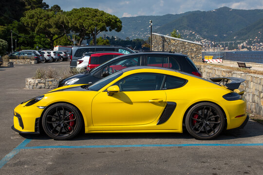 Porsche gt4 color yellow side modern sport car in public beach parking