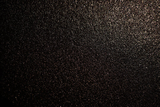 Black background of painted wall. Glossy black surface.