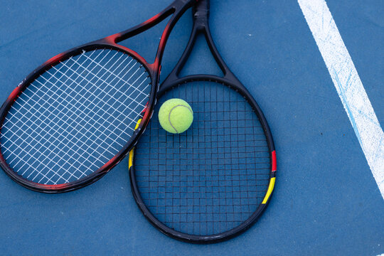 Overhead of tennis ball and tennis rackets on tennis court