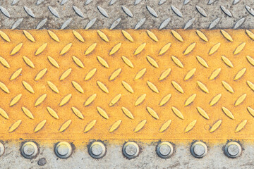 A pattern on the sidewalk with insets for the blind at a train station.