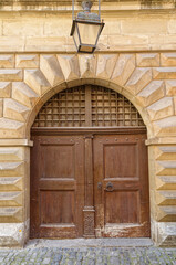 the entrance to a building with a brown door and arche